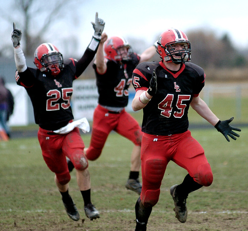 Don Campbell / H-P staff
Lakeshore's Brian Nekic (45), Eric Shirley (25) and Mike Solak (43) celebrate a fumble recovery during the second half against Caledonia Saturday, November 11, 2006, at Lakesh