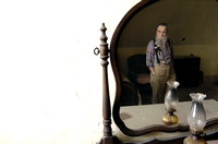 Don Campbell / H-P staff
Lloyd Dalager, president of the House of David, is reflected in a mirror as he looks over one of the bedrooms that needs renovation, Wednesday, October 4, 2006, in the Shiloh
