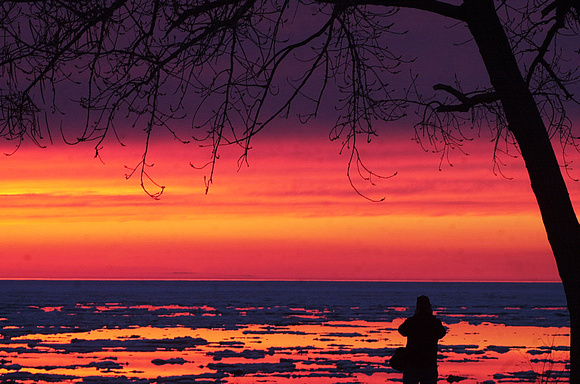 Don Campbell / H-P staff
A photographer takes advantage of Tuesday night's sunset, as well as the remaining ice in Lake Michigan along Silver Beach in St. Joseph.