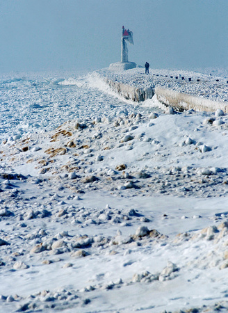 Don Campbell / H-P staff
A lone walker makes his way down an ice covered South Pier Tuesday, February 20, 2007, in St. Joseph.
