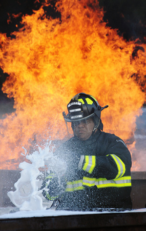 Don Campbell / H-P staff
Benton Harbor Public Safety Officer Jared Graves demonstrates the use of compressed air foam to extinguish a controlled fire during a town hall meeting Wednesday, August 31, 2