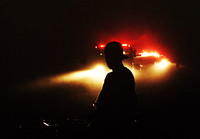 Don Campbell / H-P staff
Smoke fills the air as a young boy watches as Benton Twp. firefighters battle a house fire along St. James Street, late Monday night.