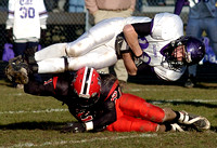 Don Campbell / H-P staff
Lakeshore's Mike Crocker (21) upends Caledonia's Steven VanderVeen (38) during the fourth quarter Saturday, November 11, 2006, at Lakeshore High School.