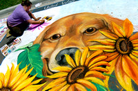 Artist Midnite Remisoski, from Benton Harbor, Mich.,  works on a chalk drawing of a Golden Retriever Saturday, August 11, 2007, during the annual Chalk on the Block held in downtown St. Joseph, Mich.