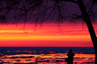 Don Campbell / H-P staff
A photographer takes advantage of Tuesday night's sunset, as well as the remaining ice in Lake Michigan along Silver Beach in St. Joseph.
