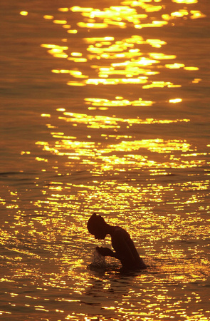 Don Campbell / H-P staff
Children swim in Lake Michigan, near Silver Beach during a late afternoon sunset.