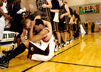 Don Campbell / H-P staff
Benton Harbor's Justin Webb is comforted by Holt's Andy Clark after the Tigers lose 58-54 in overtime during Friday, March 11, 2005, game at Loy Norrix High School in Kalamazo