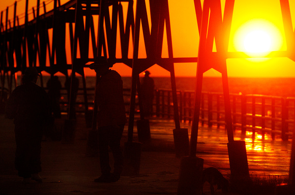 Don Campbell / H-P staff
Walkers make their way along the North Pier during Sunday night's sunset/