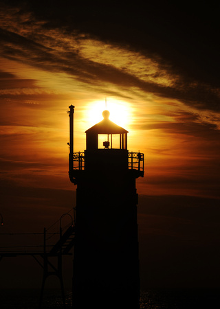 The sun sets on the South Haven Lighthouse Friday January 6, 2012.