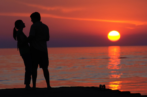 A couple enjoy a setting sun along Lake Michigan in St. Joseph Sunday, July 31, 2011.