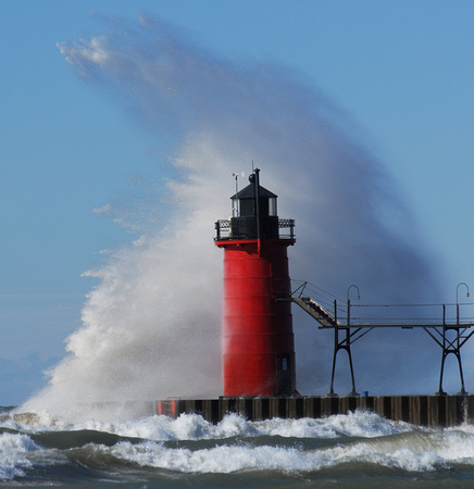 Waves crash over the South Haven Lighthouse in South Haven, Mich., October 27, 2010.