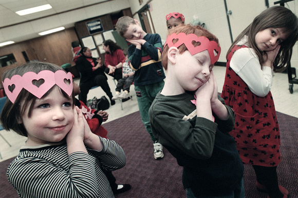 From left to right, Maya Murphy, 4, Ryan McCoy, 4, and Audrey Conrad, 4,  sing songs during storytime, Wednesday morning at the Benton Harbor Public Library. Children watched movies, made valentines a