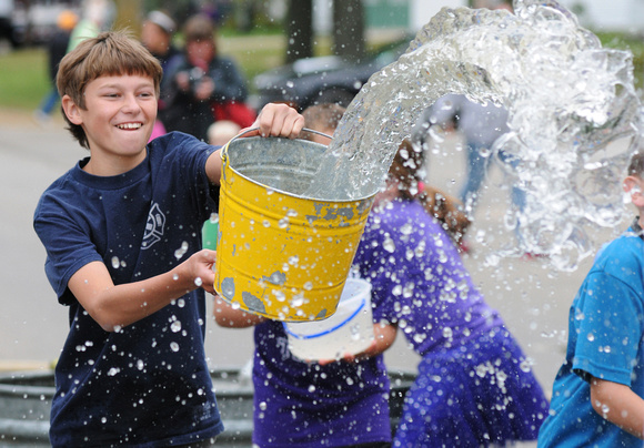 Don Campbell / H-P staff
Thirteen-year-old Kyle Leach, from Lawrence, competes in the Bucket Brigade, one of the many activities held during the 90th anniversary of the Lawrence Ox Roast & Homecoming