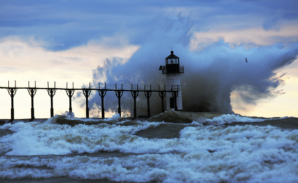 Waves crash into the outer light of the St. Joseph Lighthouse Sunday, December 25, 2011.