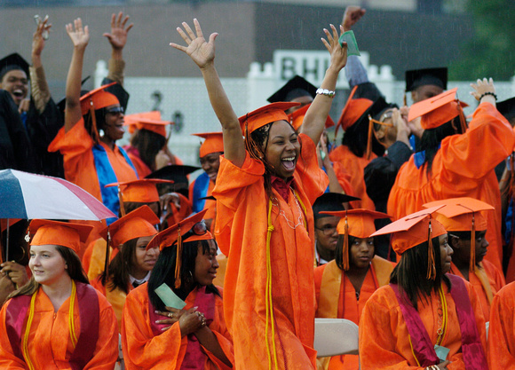 Don Campbell / H-P staff
Despite a brief downpour, Precious Shaquell Smith, center, joins Benton Harbor High School seniors as they celebrate during the 133rd Commencement Exercise for the class of 20