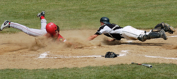Don Campbell / H-P staff
Stevensville Post 568's Chris Haas stretches to avoid the tag from West Michigan Elite's catcher, Mike Medema (7) and score during the second inning of the Championship game o