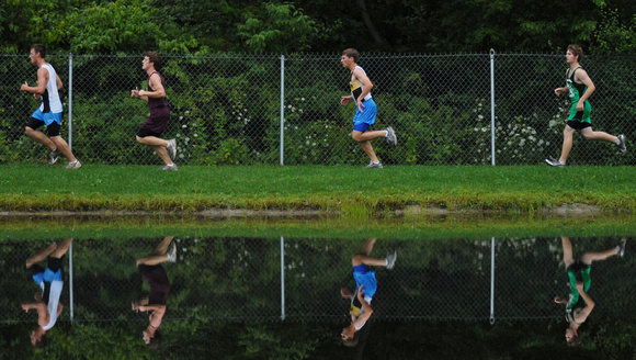 Don Campbell / H-P staff
Runners are reflected in a pond as they compete in the Bridgman Cross Country Invitational Wednesday, August 26, 2009, at Lake Township Park in Bridgman.